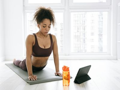 Close up of yoga mat and water bottle in dark room